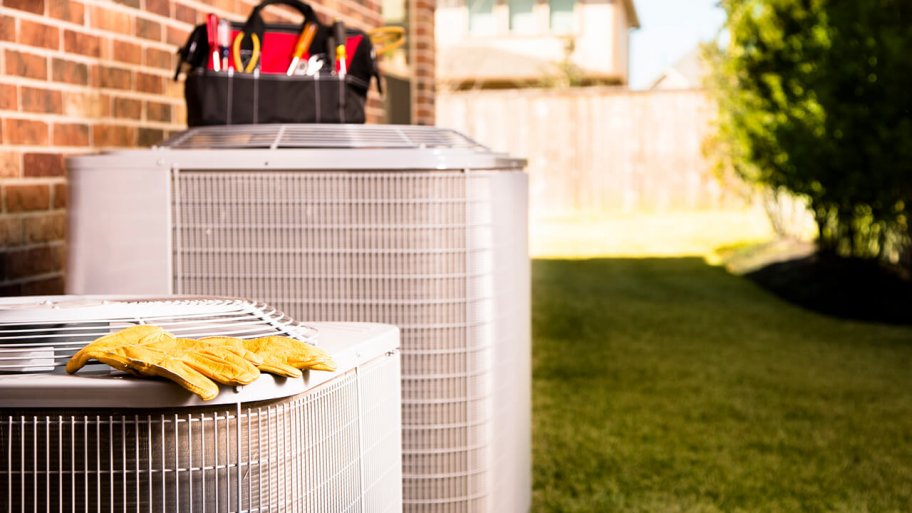 Work gloves and tools on top of air conditioning units